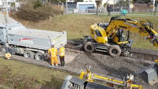 Zweiwegebagger und LKW Schotter aus lehrt