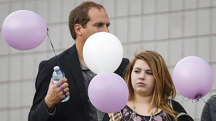 Mourners release balloons for slain father and dau...