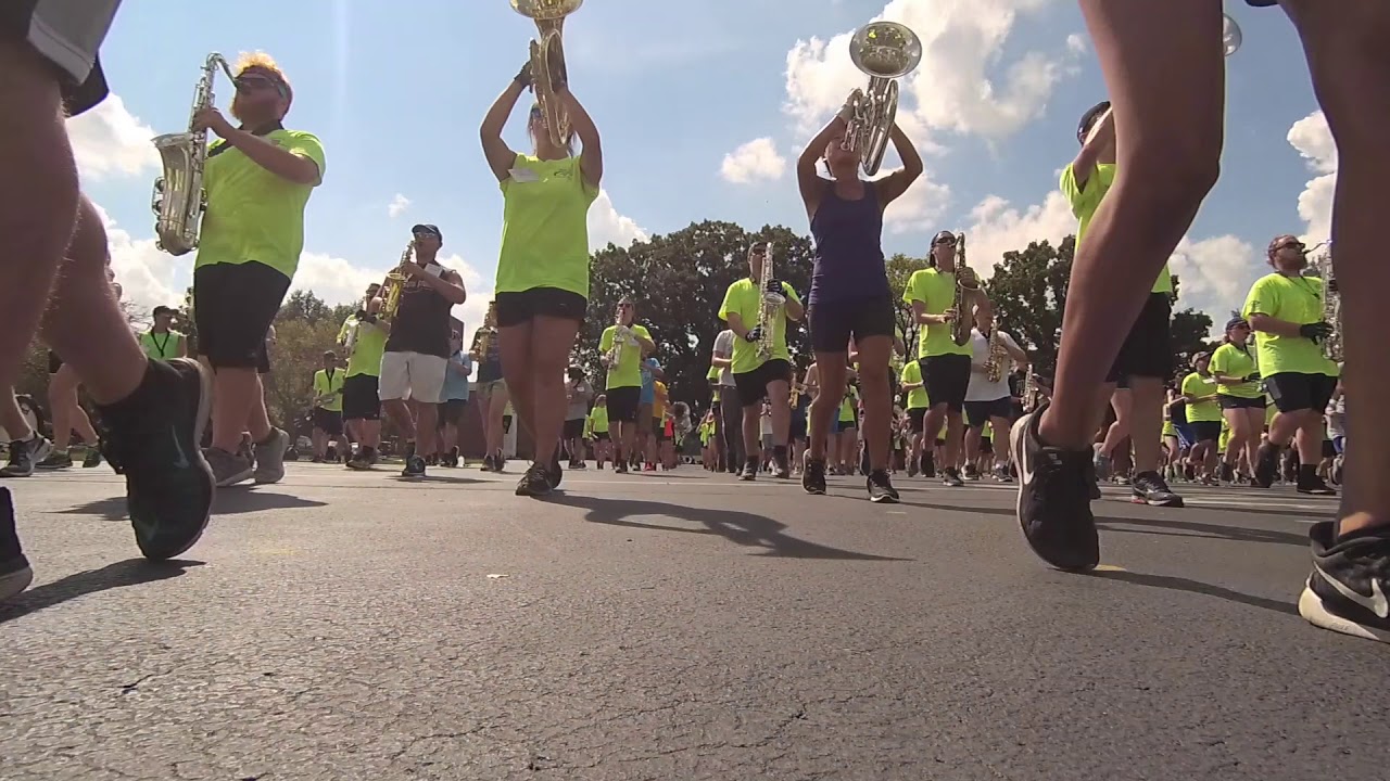 A marching band rehearses to support music in our schools