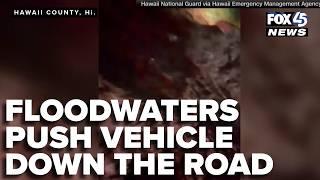 Floodwaters push vehicle down Hawaii road during Tropical Storm Lala