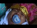 In golden crown, Indonesian girl howls through circumcision