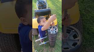 Kaiden installing wheels for lawn tractor lawn striper.