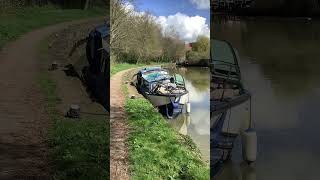 Small cruiser boat moored up on the towpath at Belgrave lock In Leicester on Grand Union canal