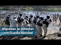 A pedradas y gas chocan Guardia Nacional y caravana migrante