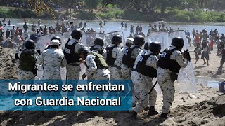 A pedradas y gas chocan Guardia Nacional y caravana migrante