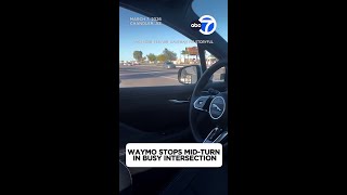 Waymo stops mid-turn in busy intersection