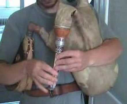 This is a Croatian Bagpipe from the Drava River Region. It is made and played here by Andor Vegh, who makes the best looking and sounding Croatian bagpipes. This video was shot in the kitchen door of Andor's residence during the Bagpipe Summer School in Szenna 2007. The twobored bagpipe system is used by all nations within the Carpathians including Slovakians, Hungarians, Rumanians, Serbians and Croatians. This bagpipe system was used in the Northern part of Croatia because the major portion Croatia and Hungary were part of the same kingdom for about 800 years until 1918. The Drava river is today the border river between Hungary and Croatia. The Hungarian side of the river is (was) partly (mostly) populated by Croatian speaking people. The four-reed chanter, you can see and hear here, is used by Croatian speaking people only. The four bores of this type of "Podravine" bagpipe are closed on the bottom. That is, when all the holes are coverd, no sound is coming out from the chanter. This makes possible staccato playing. The colsed bottom bores gives a special tone characteristic to the chanter, too. The bagpipes used by Hungarians have two bores, in some regions three, but never four. Plus, the bores are never closed at the end. Since this particular Drava-River Bagpipe set is in the key of A and most Hungarian sets of bagpipes are in A, they sound a bit similar. But, for a piper's trained ears they sound significantly/completely different. Also, the music played on these <b>...</b>
