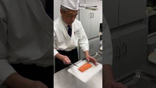 Chef Kaoru Yamamoto slicing salmon