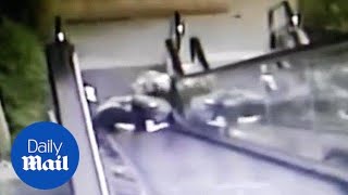 Moment OAP couple tumble down escalator before being rescued