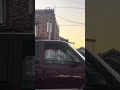 A chicken waiting in the passenger seat of a truck at sunset