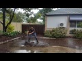 Plumber clearing a blocked grate after storm