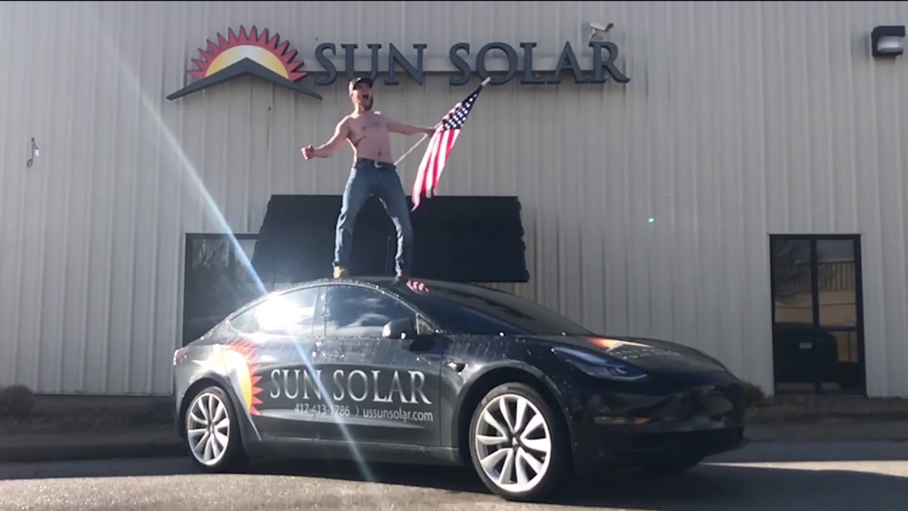Guy Stands On Roof Of Tesla Model 3 Celebrates American Made Guy Stands On Roof Of Tesla Model 3 Celebrates American Made Solar Panels