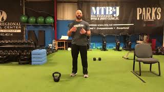 Single arm Kettlebell dead bug with opposite leg extension