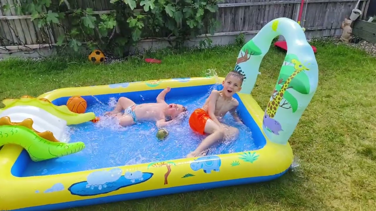 Boy jumps over slide into inflatable kiddie pool and accidentally knees baby brother on head