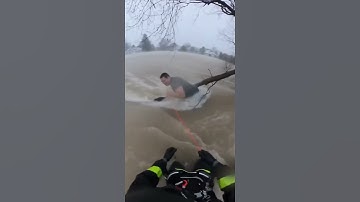 Firefighter Saves Man From Raging Floodwaters