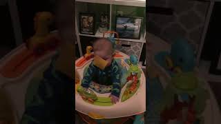 Guy throws American cheese at baby seated in bouncer
