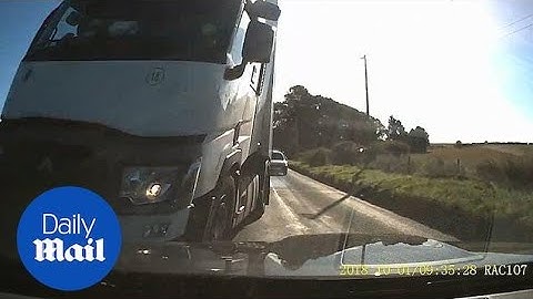 Car narrowly avoids head-on crash with truck on wrong side of road