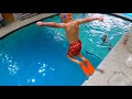 Cute Kids Jumping into the Pool at Scuba Adventure