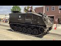 Cold War era M75 Armored personnel carrier (apc) leads a parade of military vehicles.#army
