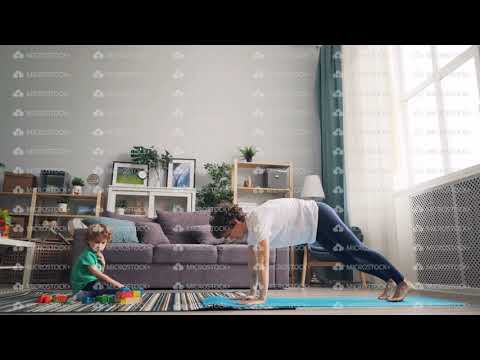 modern-housewife-doing-yoga-while-her-little-child-playing-with-blocks-on-carpet