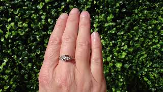 A vintage three stone diamond cross over ring