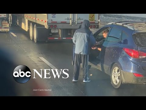 Trucker shares meal with other driver while stranded in Virginia highway.