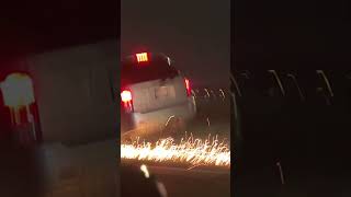 Truck Drives on 3 Wheels as Sparks Comes Out Flying From the Rim