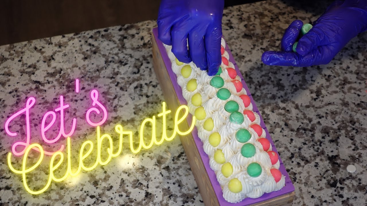 The making of frosted Celebration cold process soap with soap shavings and embeds
