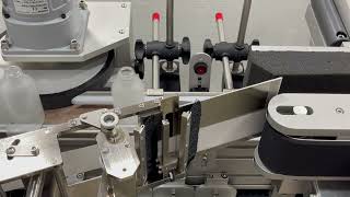 Wrap Around Labeler System Labeling Large Frosted Glass Bottles