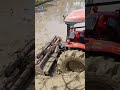 plowing the rice fields using a Kubota machine