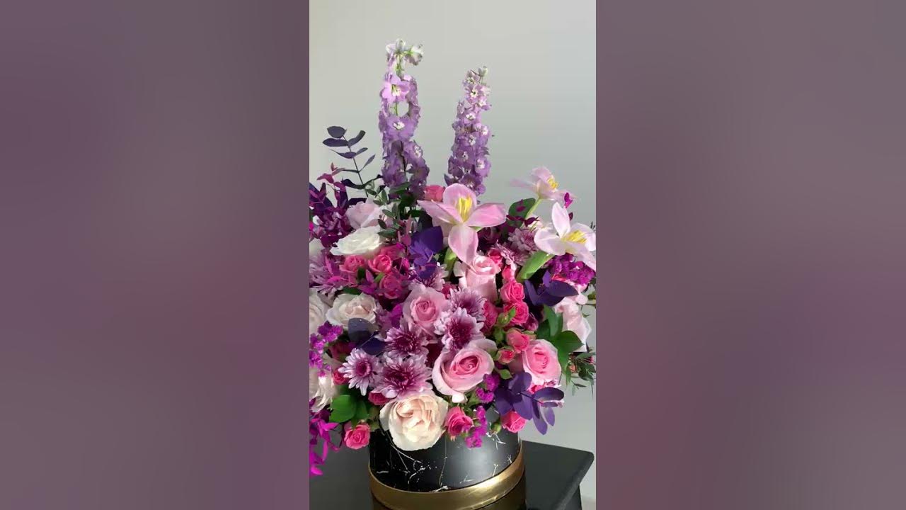 A  shades of purple, pink and white flower arrangement.