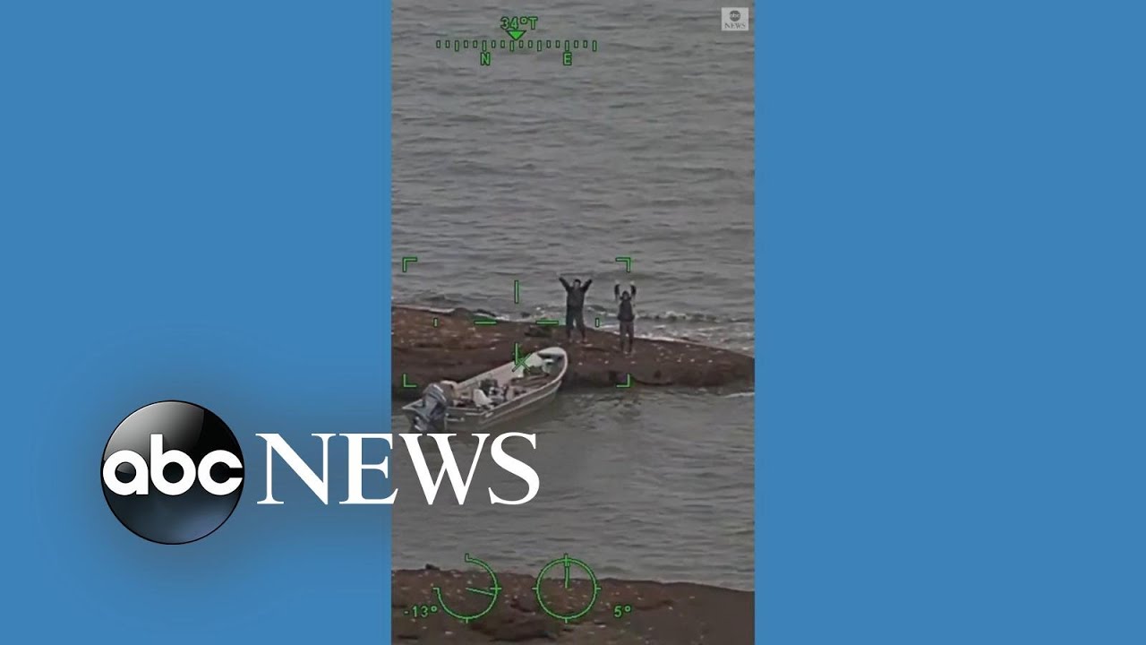 Stranded boaters celebrate as Coast Guard helicopter flies overhead