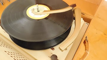 Columbia 4 speed automatic portable record player playing a couple LP records.