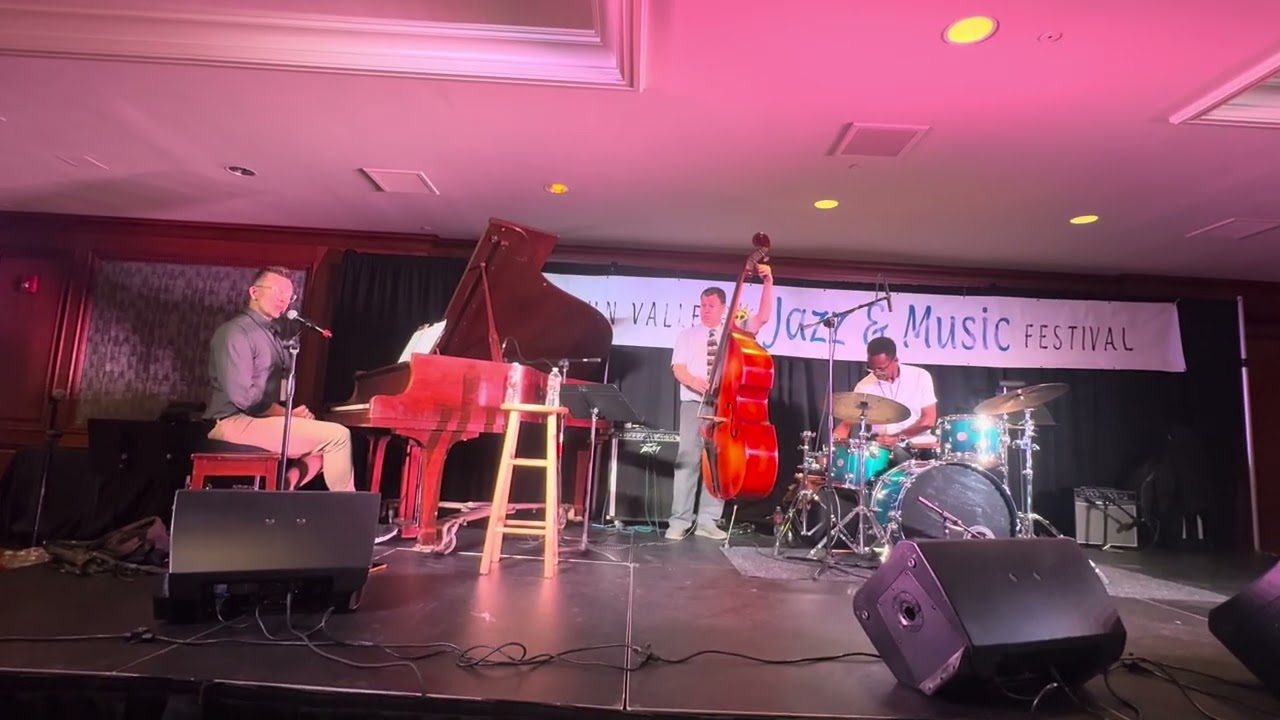 Jazz trio performing live on a nightclub stage