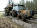 Valtra forestry tractor with big fully loaded trailer in wet forest