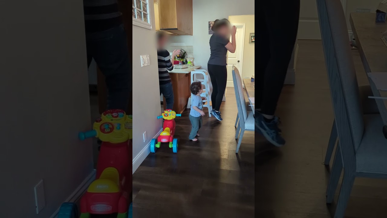 Women do the Macarena dance then little boy joins in and falls on face on toy walker/scooter