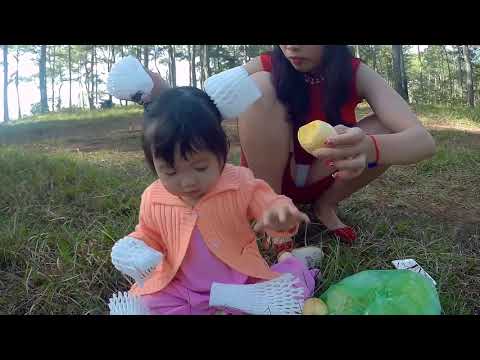 Mom of Sam - mom peels fruit for baby to eat in garden