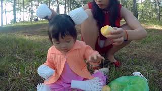 Mom of Sam - mom peels fruit for baby to eat in garden