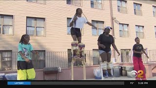 Stilt walkers prepare for Brooklyn's West Indian American Day Carnival