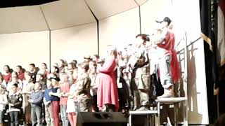 Taps played at school veterans program.