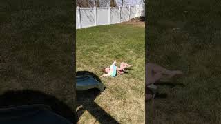 Little girl jumps from top of slide and bumps her head at the bottom