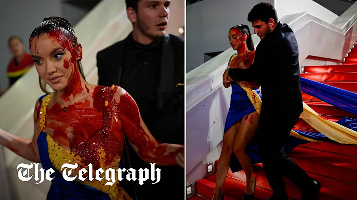 Protester dressed in Ukrainian flag colours drenches herself in fake blood on Cannes red carpet - DayDayNews