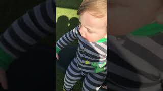 Boy spins on ride at park then falls and lands in an awkward position