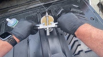 Using a coffee cup and water to prime the Wedgle Direct-Inject unit.