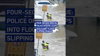 Four-second rescue: Police officer leaps into flood to save slipping woma