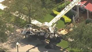 Crane falls onto Orlando home, slicing roof