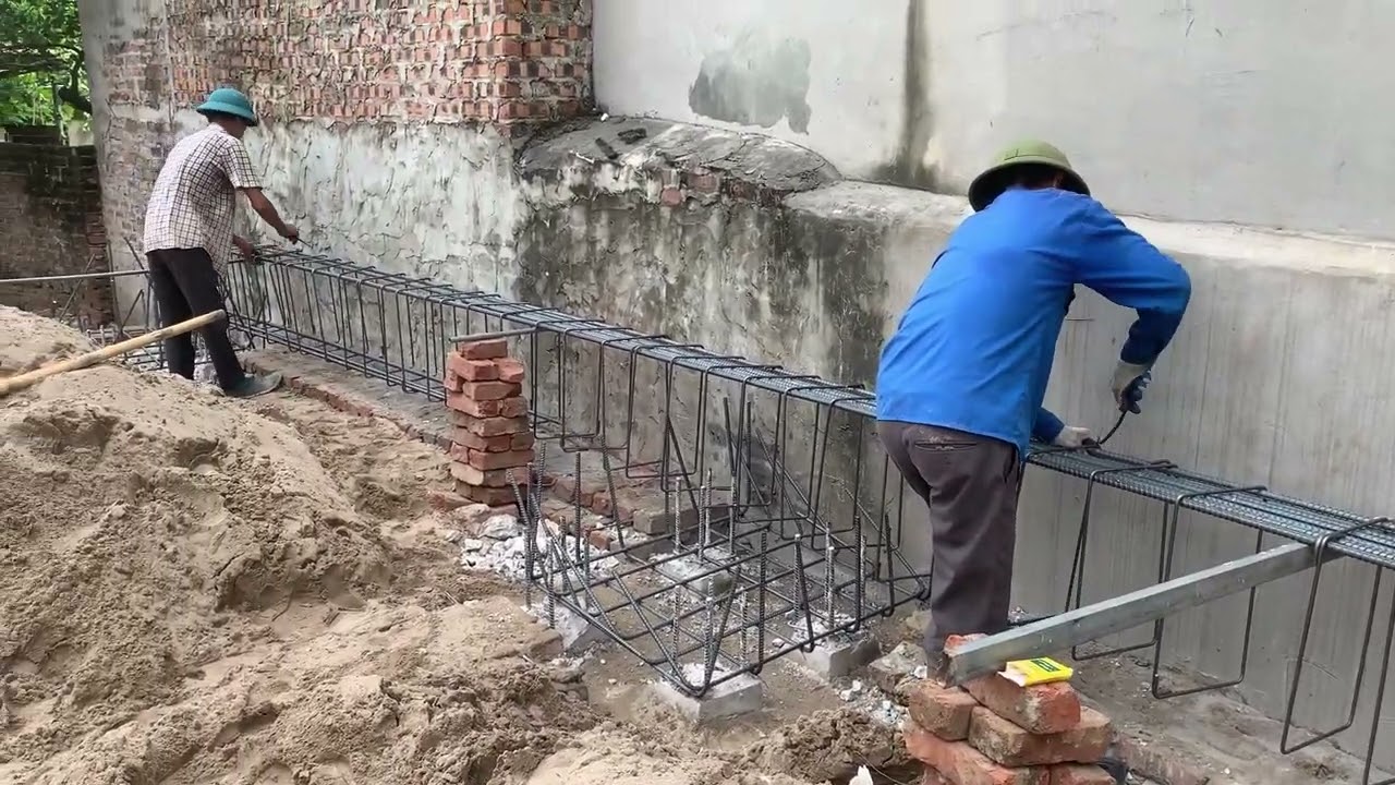 Constructing a three-story house foundation, laying the foundation, tying reinforcement steel bars