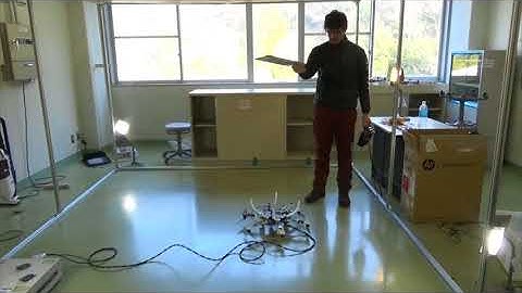 High precision positioning on ceiling employing an aerial robot  with top mounted omni wheel
