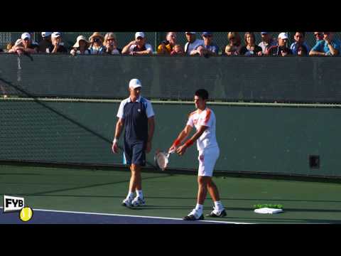 Novak Djokovic and Todd Martin practice serving dr...