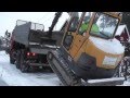 Volvo mini excavator climbing truck.